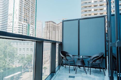 a balcony with chairs and a table on a building at King Solomon Batumi Hotel in Batumi