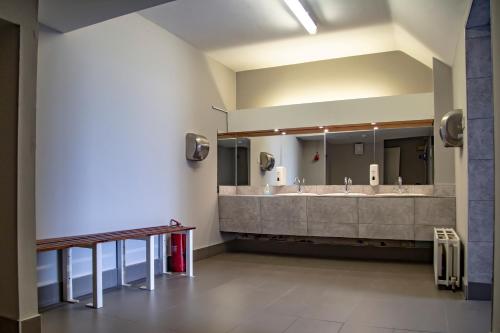 a bathroom with two sinks and a large mirror at Leevin Hostel Mountjoy in Dublin