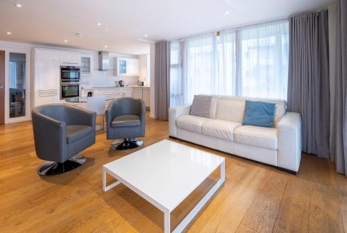 a living room with a couch and two chairs and a table at Portavadie Loch Fyne Scotland in Portavadie