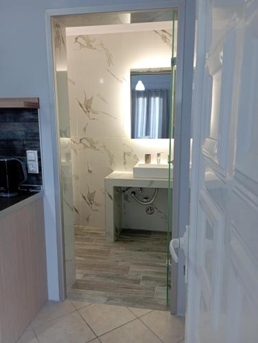 a bathroom with a sink and a mirror at NIKOS DIMAS STUDIOS in Parga