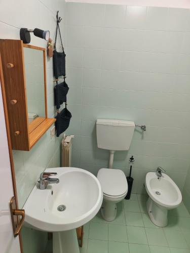 a bathroom with a sink and a toilet and a mirror at Beteyà Hostel Don Bosco in Catania