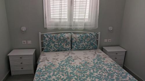 a bedroom with a bed and two night stands at Garlis Apartments in Psakoudia
