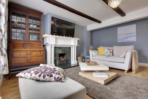 a living room with a couch and a fireplace at 10 Westgate Street Southampton in Southampton