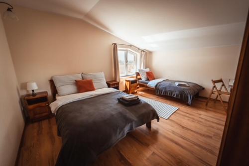 a bedroom with two beds and a window at Dom w Strzebielinku na wyłączność dom nad morzem Kaszuby in Gniewino