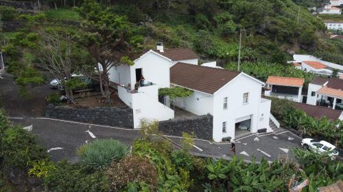 an aerial view of a white house on a hill at PICO HOLIDAY RENTALS, Casa Do Avô Faidoca in Calheta de Nesquim