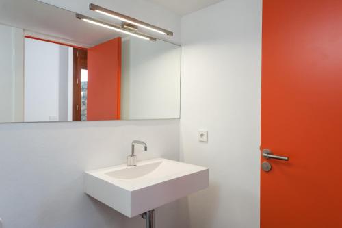 a bathroom with a white sink and a mirror at Can Cabrit in Alaró
