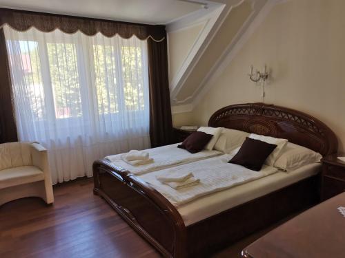 a bedroom with a large bed with a large window at Apartman Orgona in Siófok