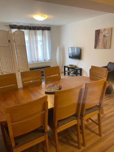 a dining room with a wooden table and chairs at Apartments Sunny Place in Rust