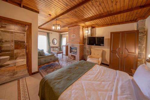 a bedroom with a large bed and a bathroom at Foleya Mountain Resort Hotel & Villas in Trabzon