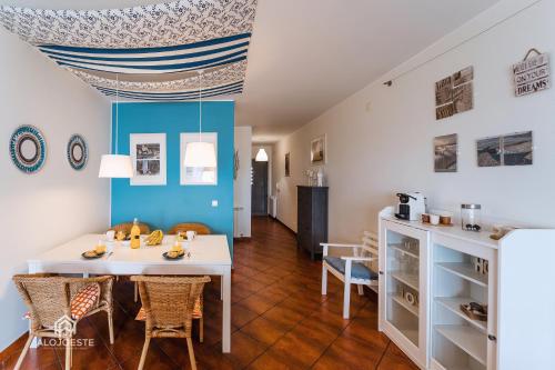 a dining room with a white table and chairs at Sun Wave Apartment - Santa Cruz in Santa Cruz