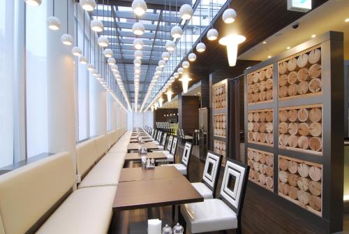 a dining room with tables and chairs and a wall of wine barrels at Citadines Central Shinjuku Tokyo in Tokyo