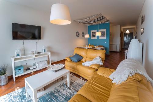 a living room with a couch and a table at Sun Wave Apartment - Santa Cruz in Santa Cruz