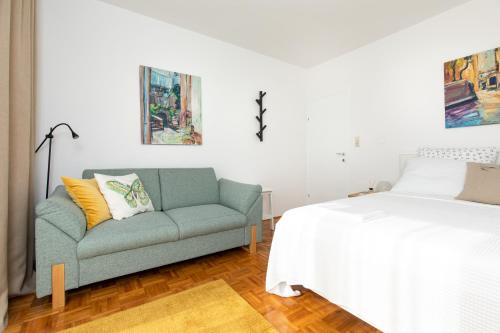 a living room with a couch and a bed at Studio Point of view in Punat