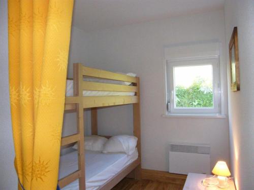 ein Schlafzimmer mit einem Etagenbett und einem Fenster in der Unterkunft APPARTEMENT À LA MONTAGNE à LA MEIJE BLANCHE in Villar-dʼArène