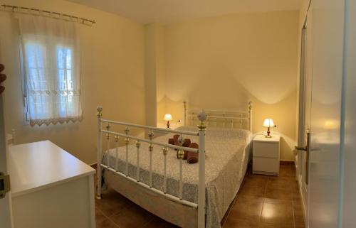a small bedroom with a bed and a window at Apartamentos Isla Canela y Punta del Moral in Isla Canela
