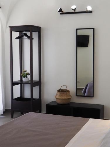a bedroom with a black shelf and a mirror at DonPè in Agrigento