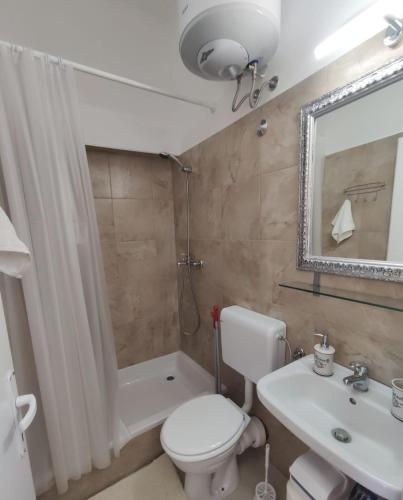 a bathroom with a toilet and a sink and a shower at Mari in Opatija