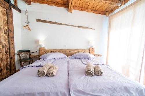 a bedroom with two beds with towels on them at Casa Coronica in Sečovlje