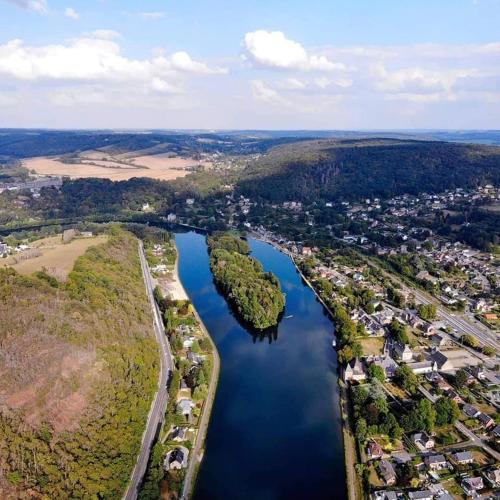an aerial view of a river with a city at L'échappée au jardin, yourte bucolique in Godinne