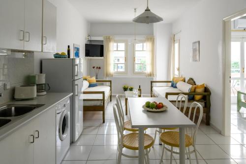 a kitchen and living room with a table and chairs at Bellevue Suites in Agios Nikolaos