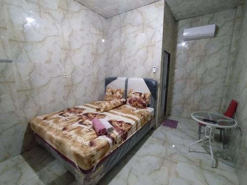 ein Schlafzimmer mit einem Bett in einem Zimmer mit Marmorwänden in der Unterkunft Near Grosir Stono 2 in Pekalongan