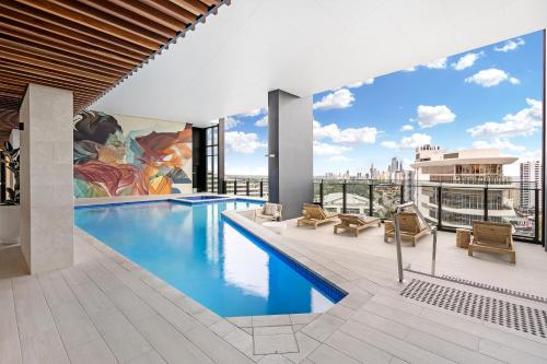 a swimming pool on the roof of a building at Lamour Ocean View Apartment II in Casino Broadbeach - free parking-195cm in Gold Coast