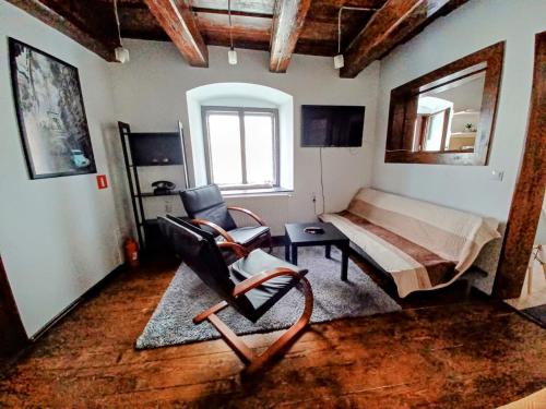 a room with a bed and a chair in it at Historic Center Apartment in Braşov