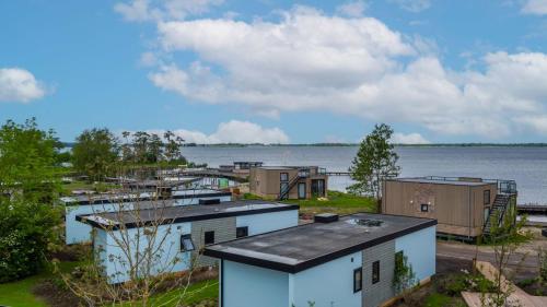 a group of buildings next to a body of water at EuroParcs De Wiedense Meren in Wanneperveen