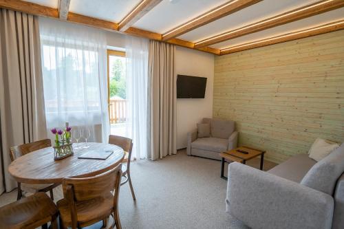 a living room with a table and a couch at Penzion Maria in Liptovský Mikuláš