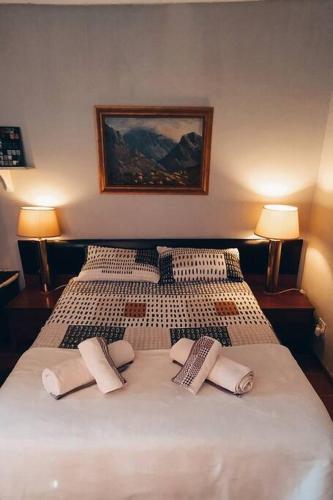 a bedroom with a bed with three pillows on it at Garden cottage in Cape Town