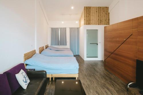 Postel nebo postele na pokoji v ubytování Wind Wave Ocean Homestay