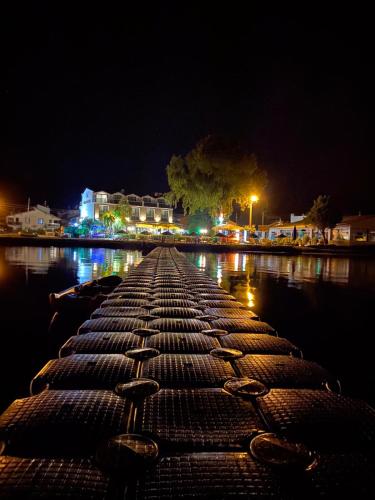 a dock at night with lights on the water at Burla Han in Urla