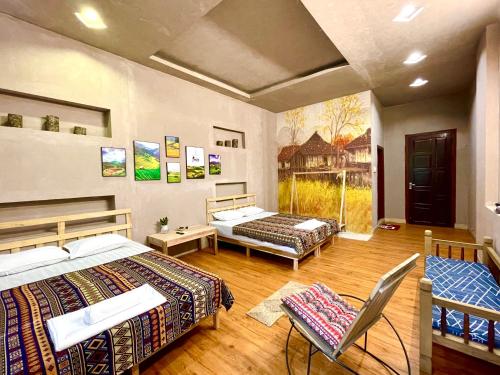 a bedroom with two beds and a chair in it at Lan home- Jeep Tour, Motobike tour, rental motobike, private car Cao Bang in Cao Bằng