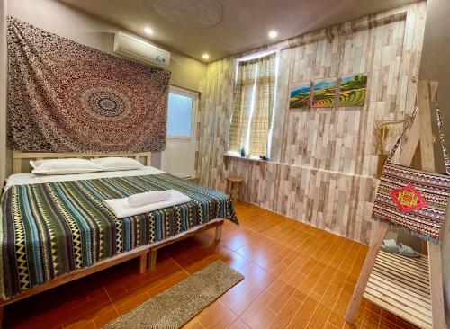 a bedroom with a bed and a chair in it at Lan home- Jeep Tour, Motobike tour, rental motobike, private car Cao Bang in Cao Bằng