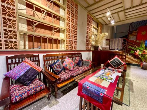 a room with two couches and a table with pillows at Lan home- Jeep Tour, Motobike tour, rental motobike, private car Cao Bang in Cao Bằng