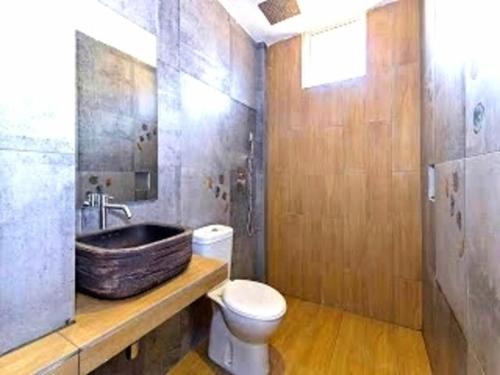 a bathroom with a sink and a toilet at Raintree Boutique Hotel in Kajang
