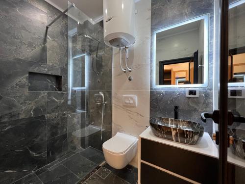 uma casa de banho com um lavatório, um WC e um chuveiro em Blue Star Apartments em Ulcinj