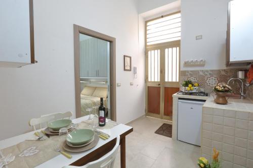 a kitchen with a table with plates on it at Casa Francesca in Avola