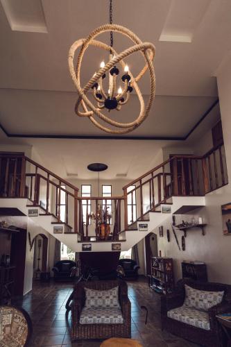 a living room with a chandelier and a staircase at Kilihouse Bb Large Ensuite Double Bedroom in Thika
