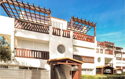 a white building with balconies on the side of it at Nice Apartment In Saint-Cyprien in Saint-Cyprien