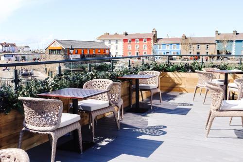 a row of tables and chairs on a balcony at Y Seler in Aberaeron