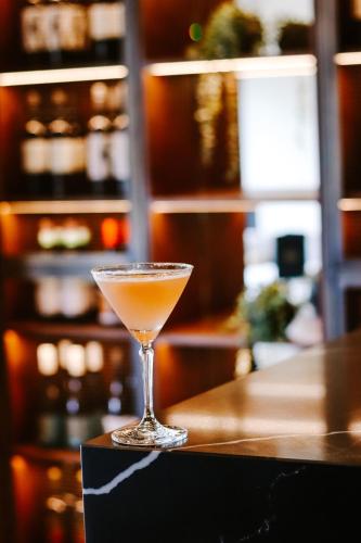 a drink in a martini glass sitting on a bar at Y Seler in Aberaeron