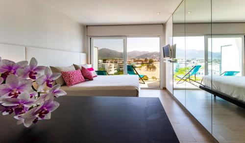 a hotel room with two beds and a large window at Hotel Maritim in Roses