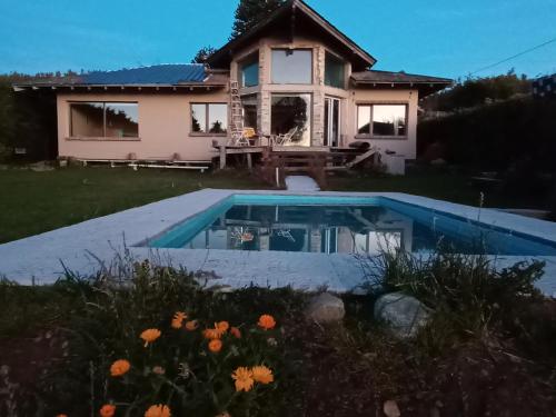 a house with a swimming pool in front of it at hermosa casa a una cuadra del lago in San Carlos de Bariloche