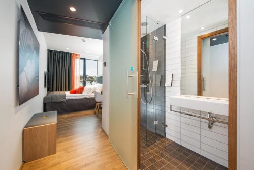 a bathroom with a shower and a sink at Clarion Hotel The Edge in Tromsø