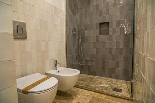 a bathroom with a toilet and a shower at Masseria Il Passo in Favignana