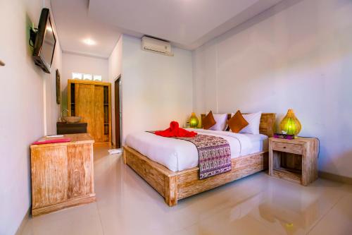 Postel nebo postele na pokoji v ubytování Dede Cottage Ubud