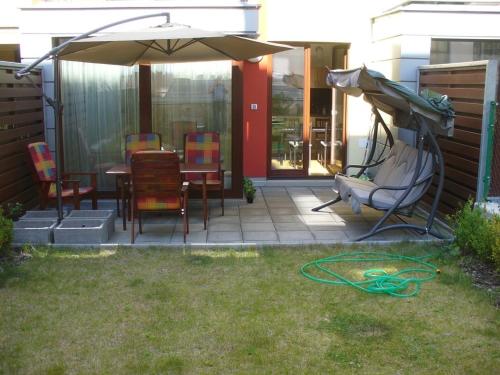 a patio with an umbrella and a table and chairs at Garden apartment with garage in central Prague in Prague