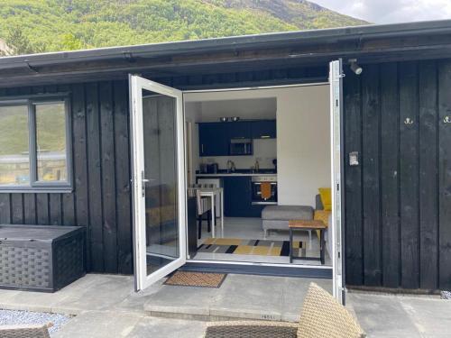a black house with a door open to a kitchen at Cosy Annex with Hot tub and Separate Bedrooms in Kinlochleven