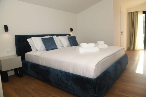 a bedroom with a large bed with towels on it at Old Town Villa in Durrës
